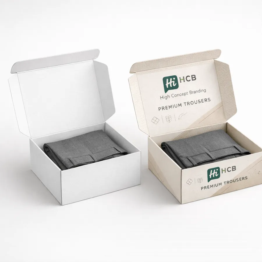 Two mailer boxes- one plain white and one branded- containing folded grey trousers for wholesale- class=